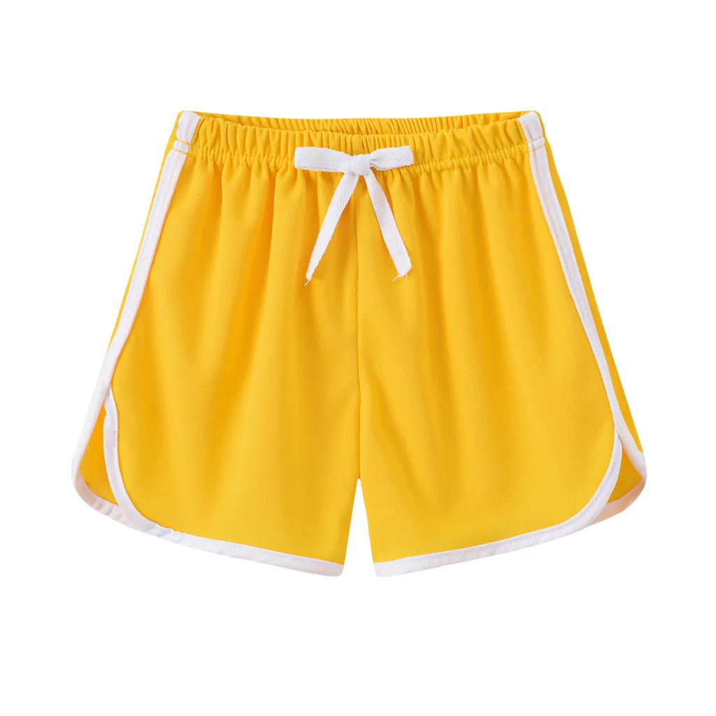 Children's patterned beach shorts in various colours including leopard print, floral, and fruit designs
