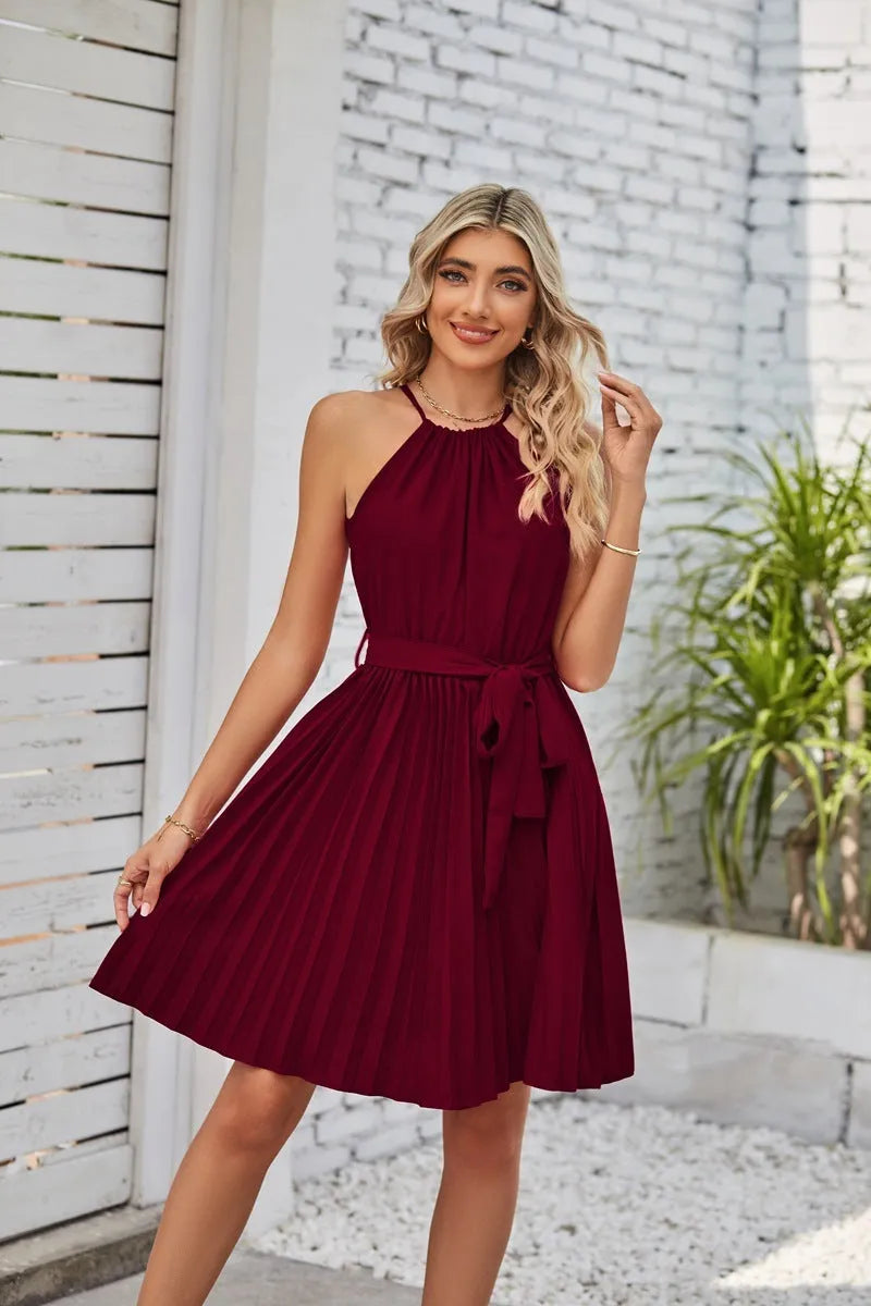 Women's black halter neck strapless dress with pleated midi skirt and waist belt