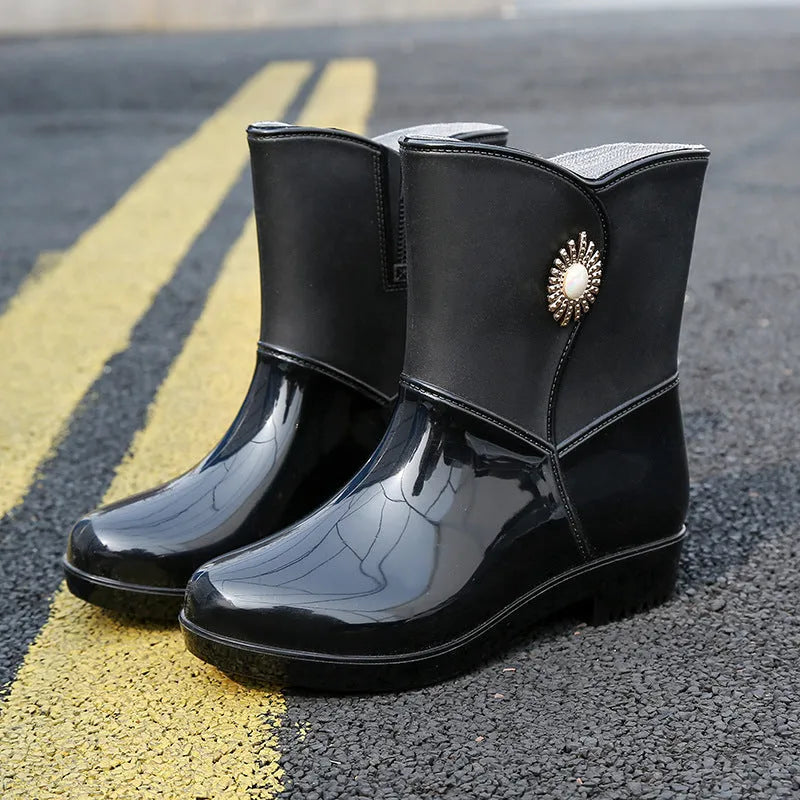 Women's purple rain boot with middle tube height and textured non-slip sole.
