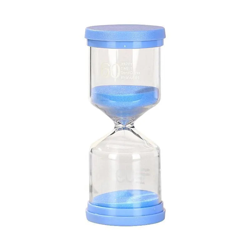 Handmade glass sand clock timer on a desk, showing purple sand, modern design.