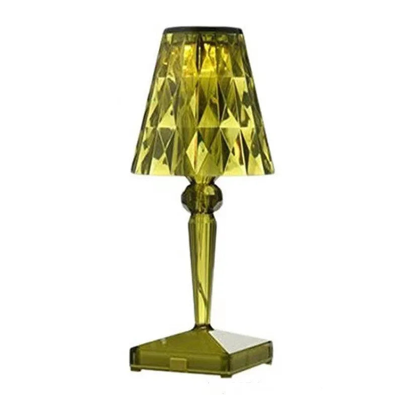 Rose gold portable touch night light with dimmable colours on a table.