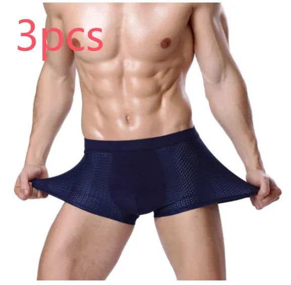 Men's solid colour ice silk modal boxer briefs with a U convex design on a mid waist.