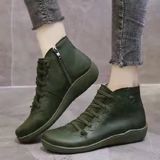 Women's casual flat booties with wedge heel and round toe in artificial PU and rubber.