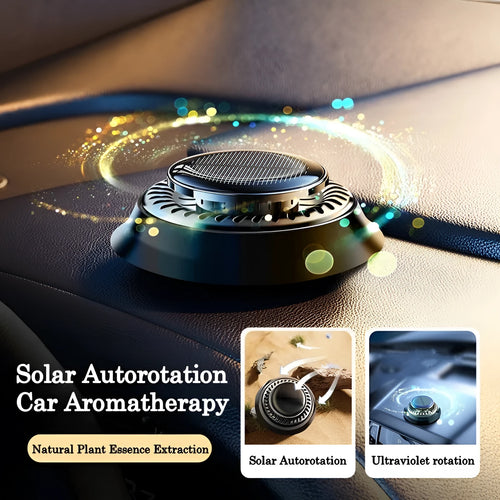Solar-powered kinetic car air freshener with rotating double rings on car dashboard