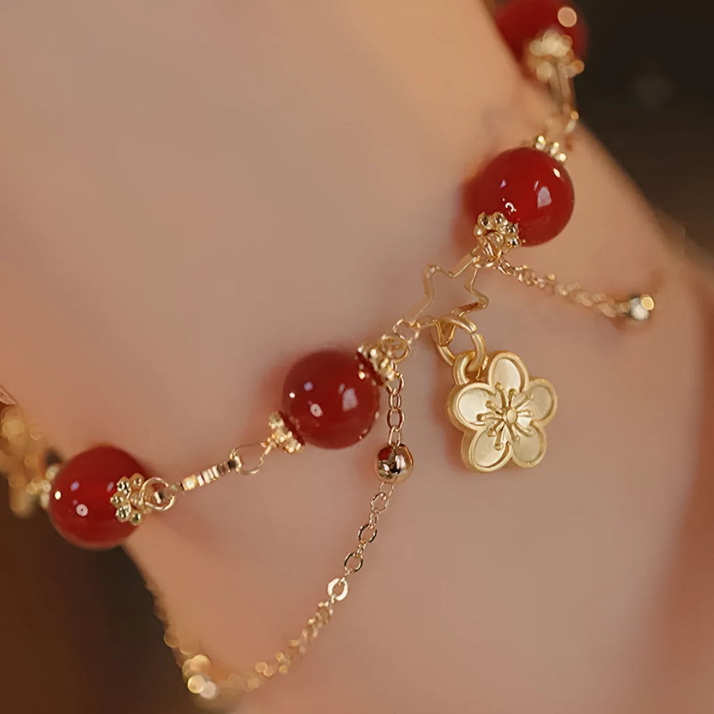 Red agate double layer bracelet for women with carved peach blossom and flower designs.
