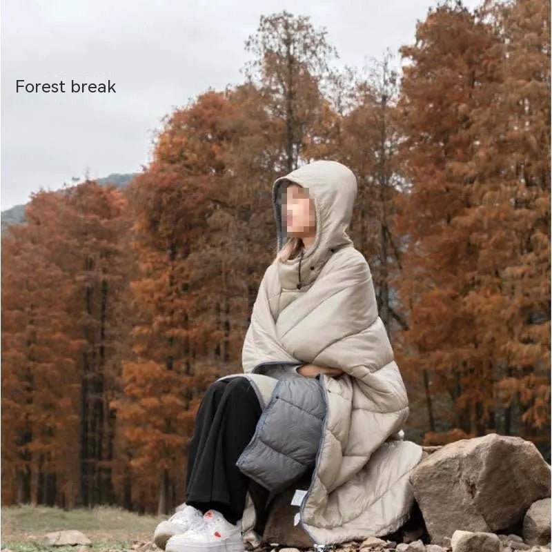 Grey outdoor cloak sleeping bag with hood showing transformation to wearable cape