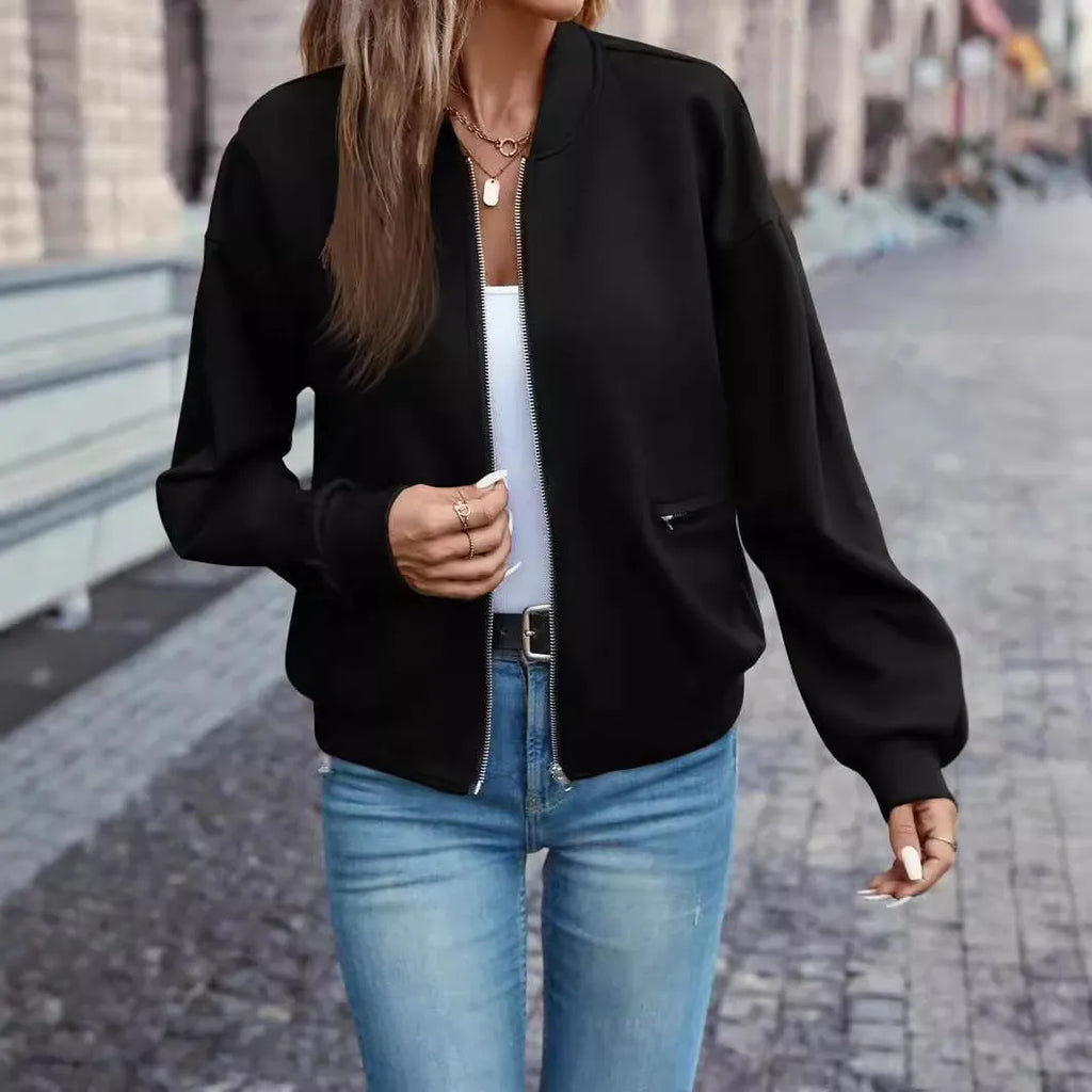Black women's zip jacket with faux pockets and long sleeves on hanger