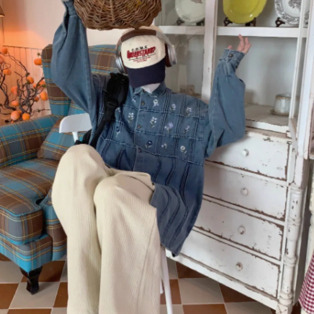 Washed blue denim long sleeve shirt with vintage small floral pleat details on the front.
