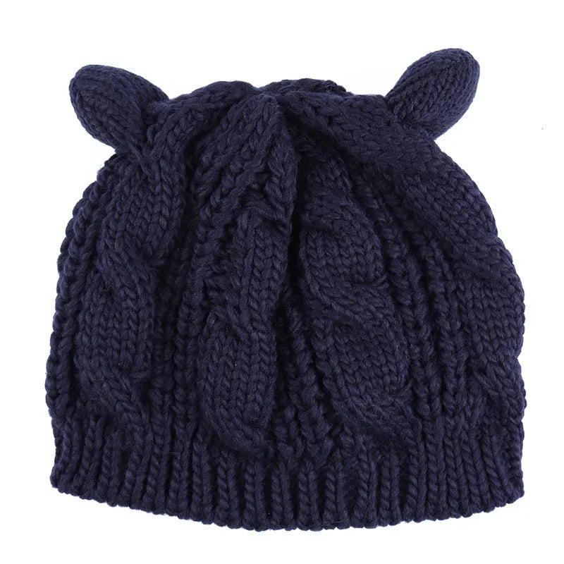 Hand-made chunky wool beanie with 3D knitted cat ears on a white background.