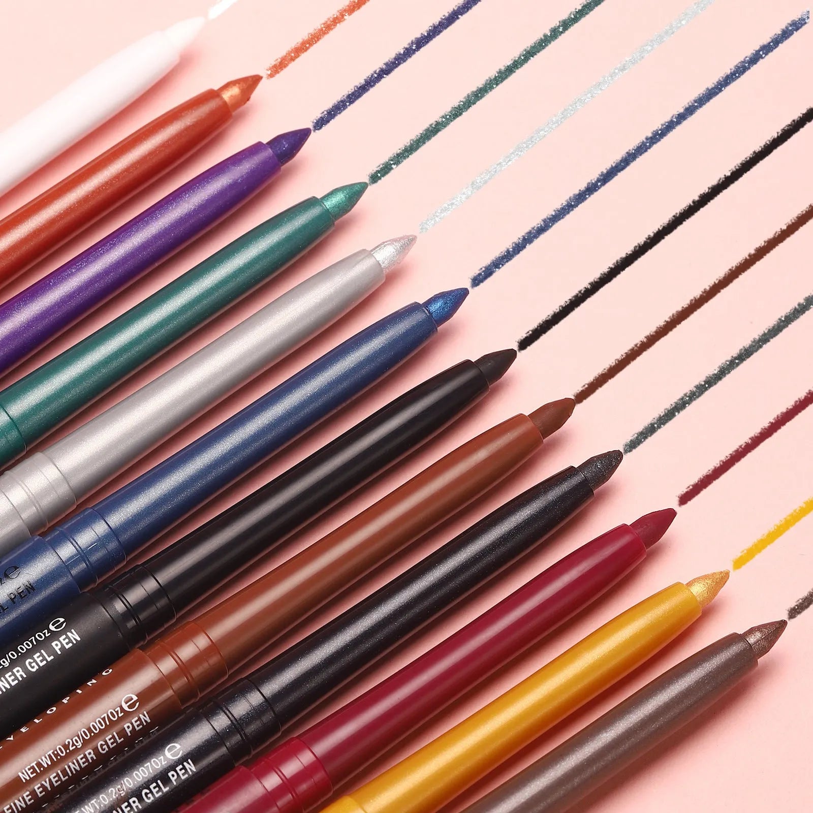 Set of 12 colourful gel glitter eyeliner pencils arranged showing metallic, matte, and glitter finishes.