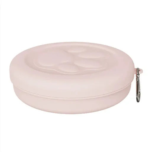 Collapsible silicone dog bowl in light pink and green colours showing portable feeding design
