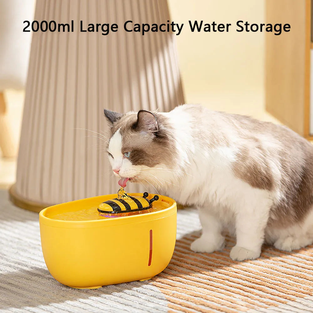 Yellow cat water fountain with filtration system, blue LED light, and water level window.