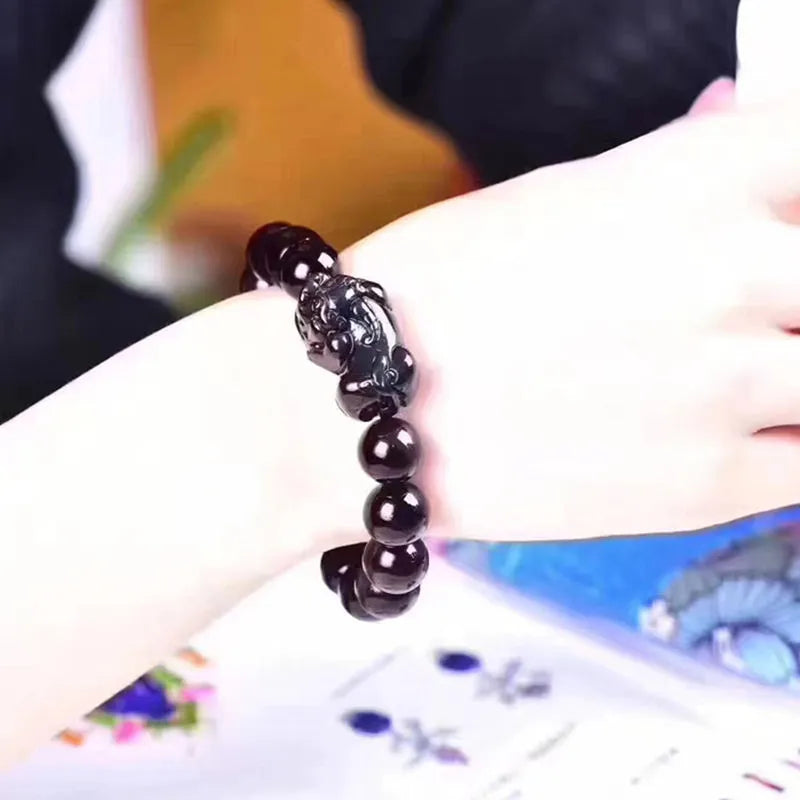 Polished natural ice colour Eye Obsidian crystal beads on an elasticated bracelet cord.