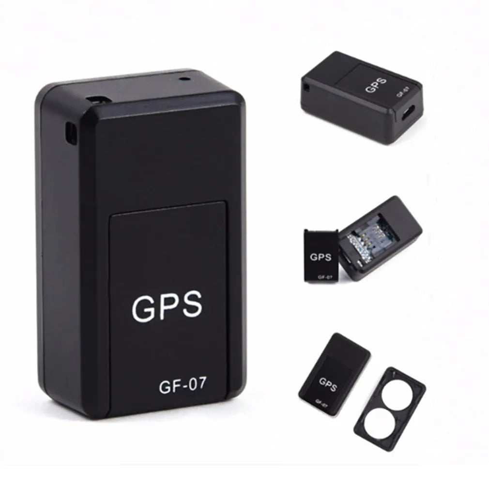 Small black plastic magnetic GPS car tracker device on a metal surface.