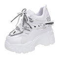 White and black women's low-top mesh platform sports shoes with cross strap and round toe.