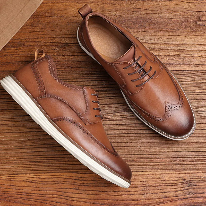 Men's black and brown slip-on business casual shoes with round toe and decorative carving detail