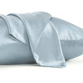 Dark grey silk pillowcase with envelope closure, shown flat and on a pillow.