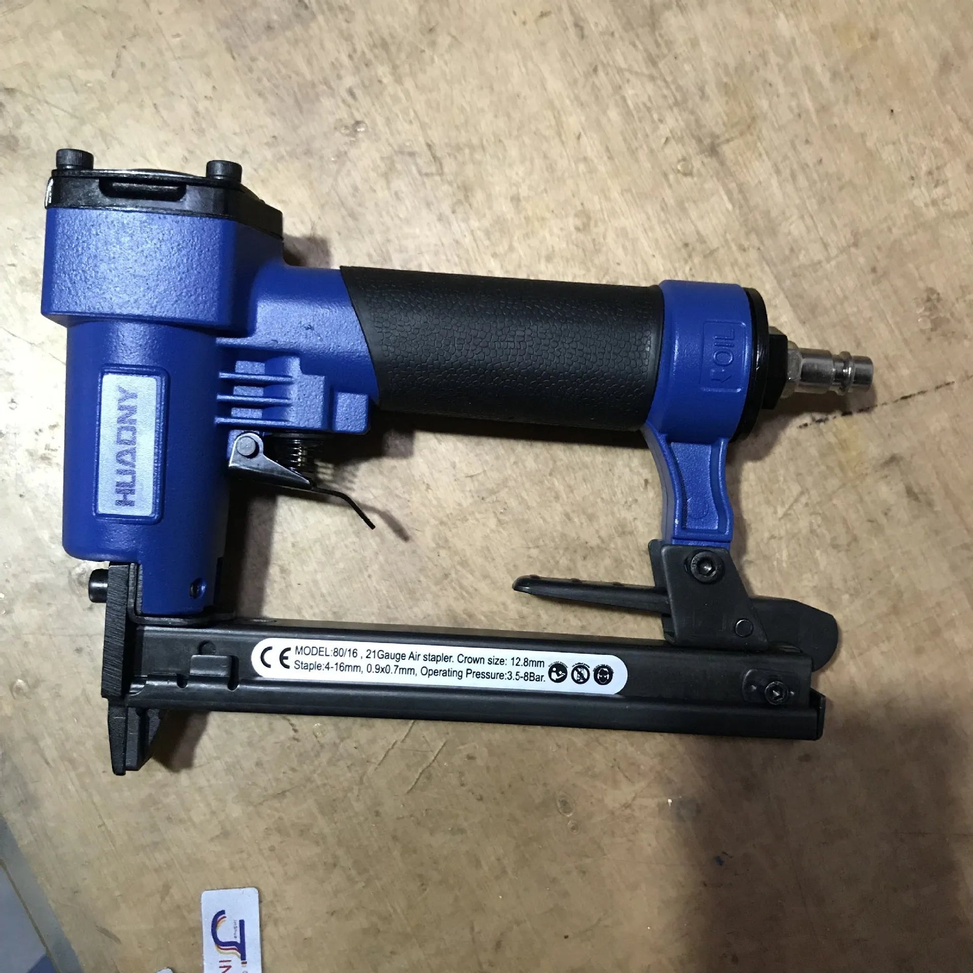 Blue pneumatic strip nail gun with American connector for decoration and upholstery work