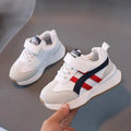 Children's white synthetic leather sneakers with Velcro fastening and a rubber sole