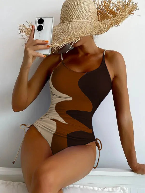 Women's sleeveless backless one-piece swimsuit in blue, shown on a mannequin.