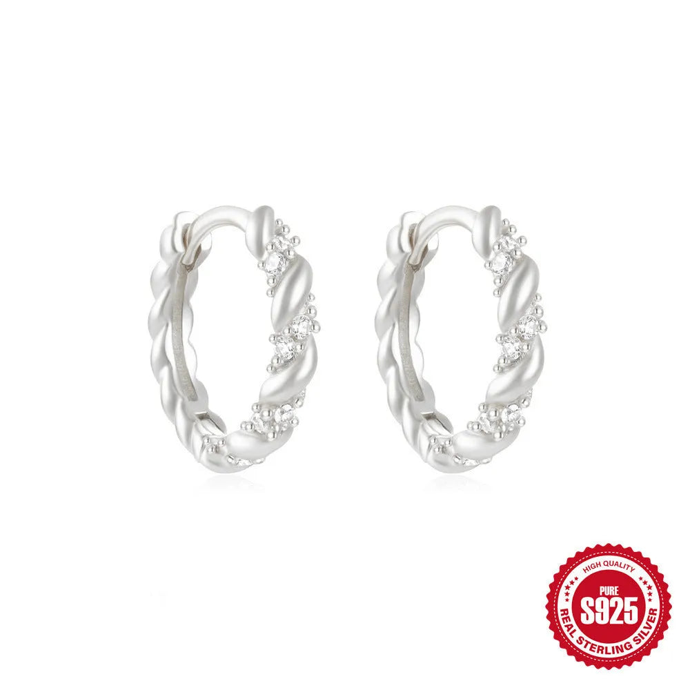 Sterling silver geometric stud earrings with small round diamond detailing in gold and silver electroplated finishes