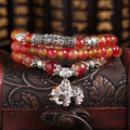 Handmade bracelet with a watermelon crystal elephant bead on a Chinese knot cord.