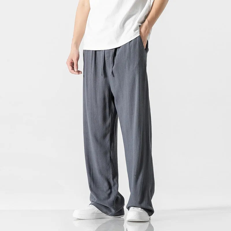 Men's beige linen casual trousers with a loose straight-leg fit and drawstring waist.