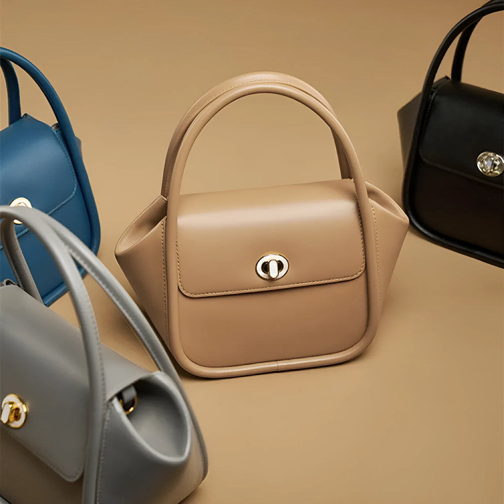 A soft cow leather wing-shaped tote handbag with a buckle and shoulder strap in black.
