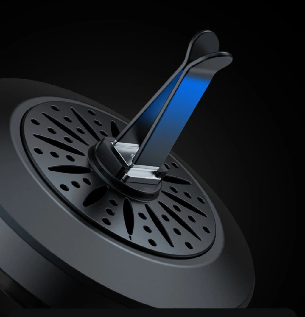 3D RGB car atmosphere light with aromatherapy mounted on a vehicle air outlet vent showing colorful lighting effects.