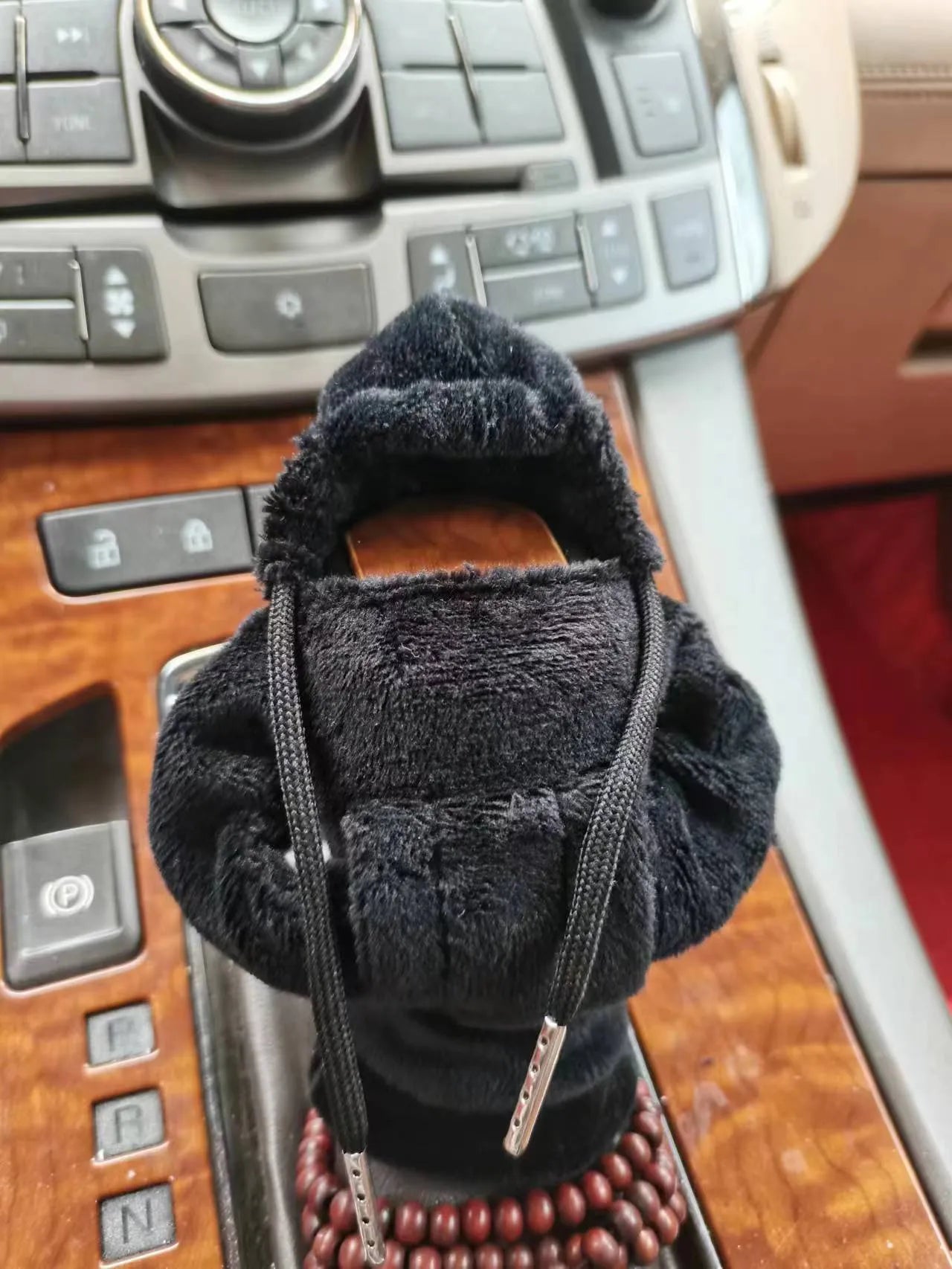 Soft Dutch velvet car gear handle cover in multiple colours on a gear stick.