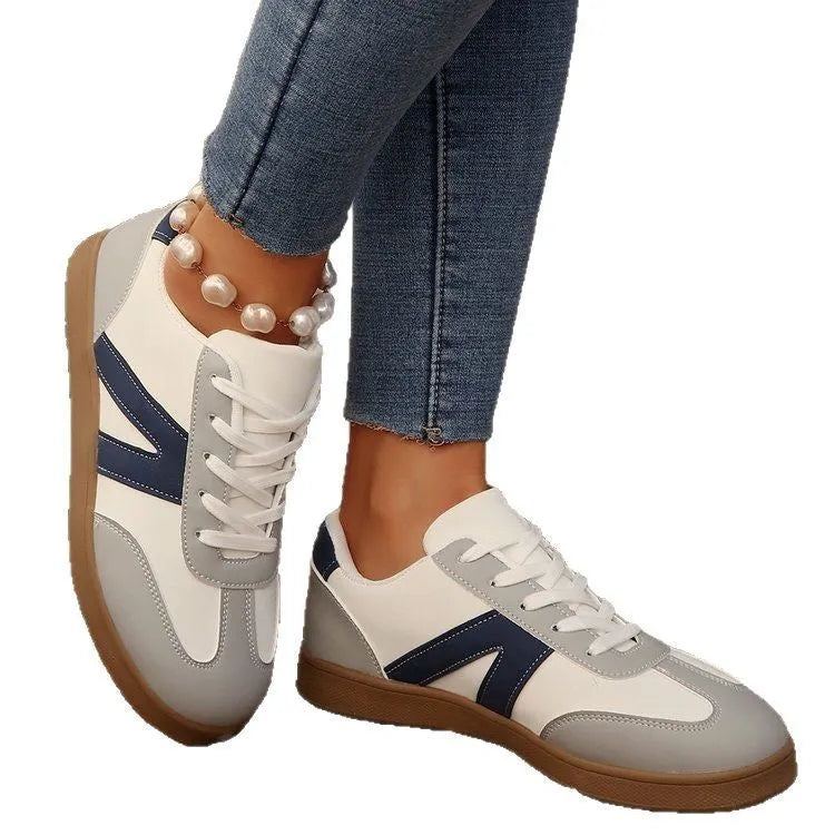 Blue women's flat German training shoes with lace-up front and rubber sole.