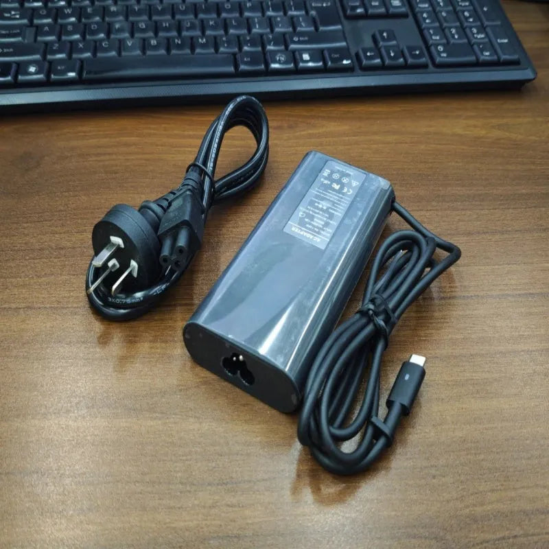 Black 65W Type-C laptop power adapter with multiple international power cords
