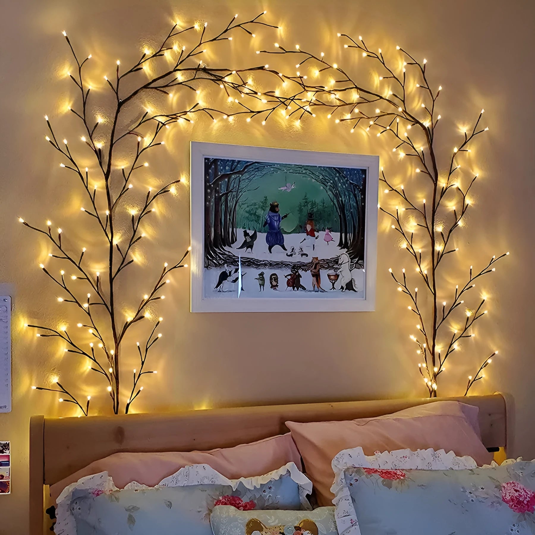 Flexible willow vine LED garland with birch bark texture and warm white lights shaped on a wall.