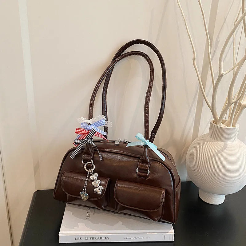 Retro brown PU leather women's shoulder bag with pillow-shaped design and double strap.