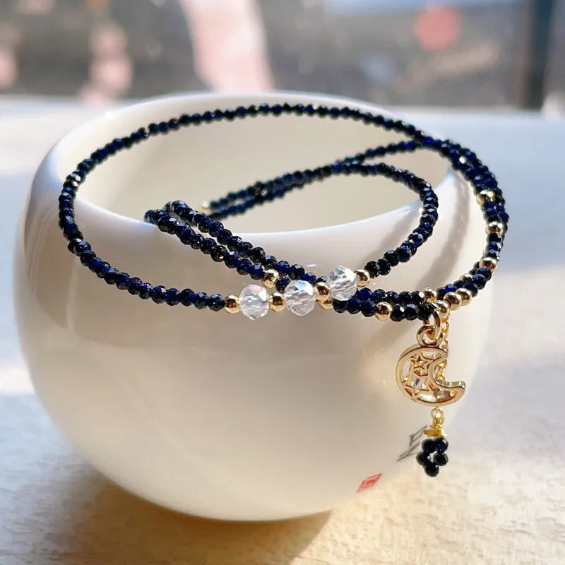 Handmade multi-layer women's bracelet in blue sand colour with three rings and stone-cut beads.