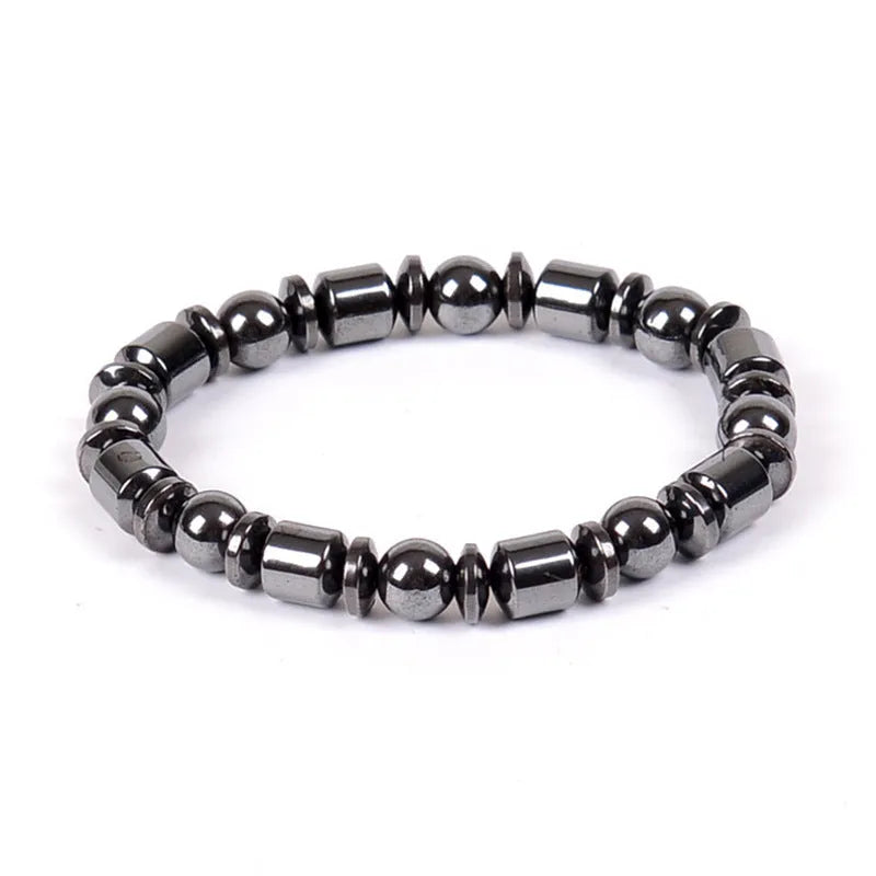 Black pentagram magnetic bracelet with magnetite and hematite stones on a wrist.
