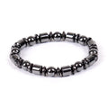 Black pentagram magnetic bracelet with magnetite and hematite stones on a wrist.