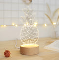 Cartoon pineapple table lamp with wood and acrylic construction on bedside table