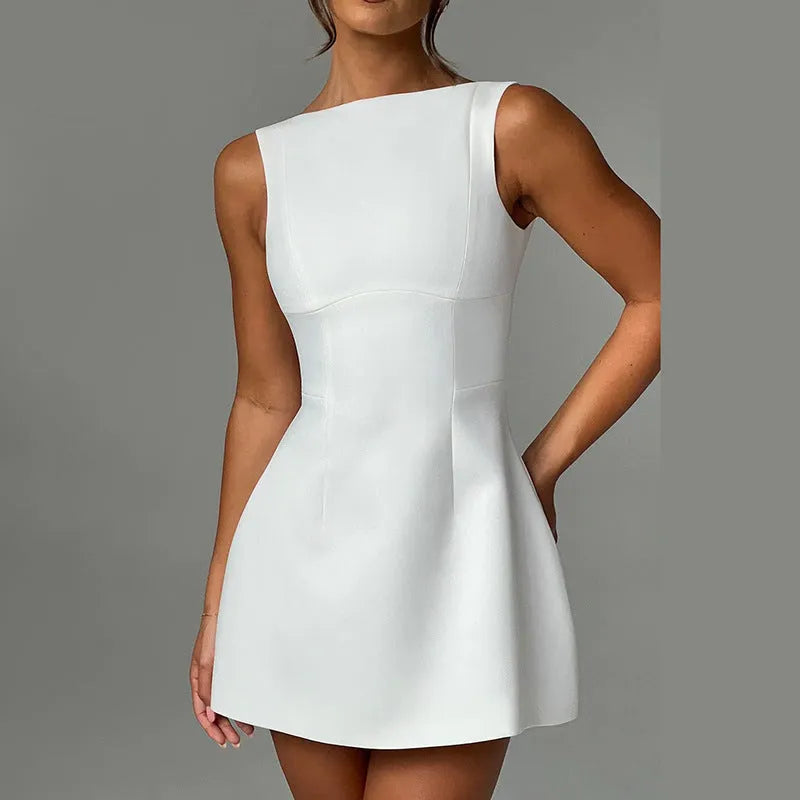 A woman wearing a slim-fitting black backless sleeveless summer dress with a high waist and short skirt.