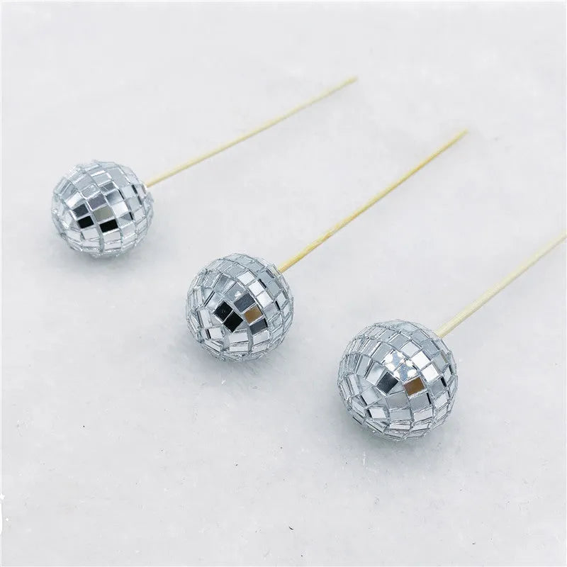 Glass disco ball cake decoration on a wooden stick, shown in different sizes for cake topping.
