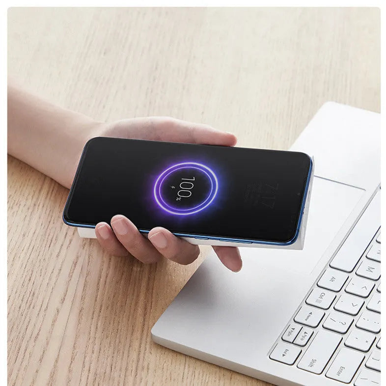 White and black 10000mAh power bank with USB Type-C port and wireless charging surface.