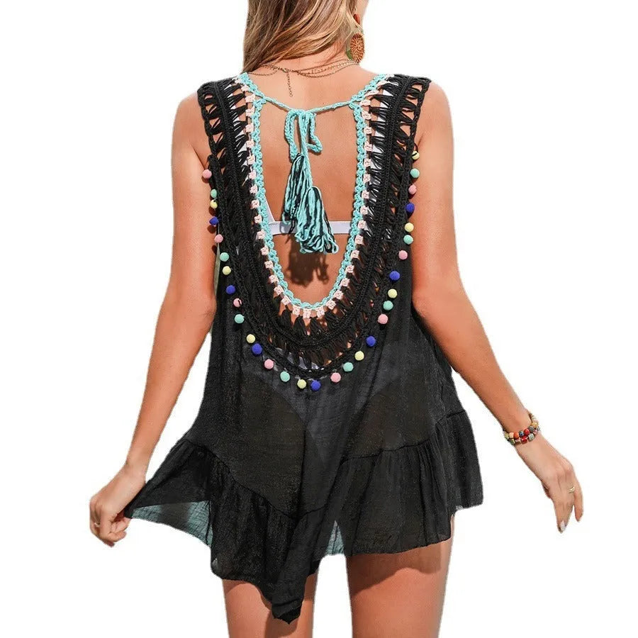 Black hand-crocheted women's beach cover-up vest with cut-out detail and ruffled hem.