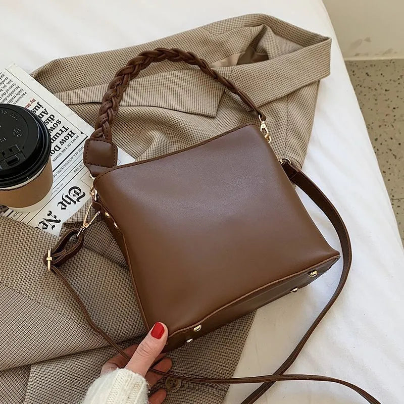 Retro khaki crossbody bucket bag with woven PU detailing and adjustable strap.