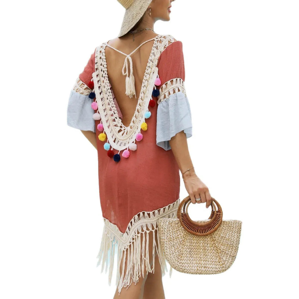 Orange floral beach overskirt with hand-crochet tassel details on mannequin