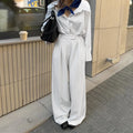 White wide-leg trousers with vertical stripes, loose casual fit, zipper detail, suitable for commuting and office wear