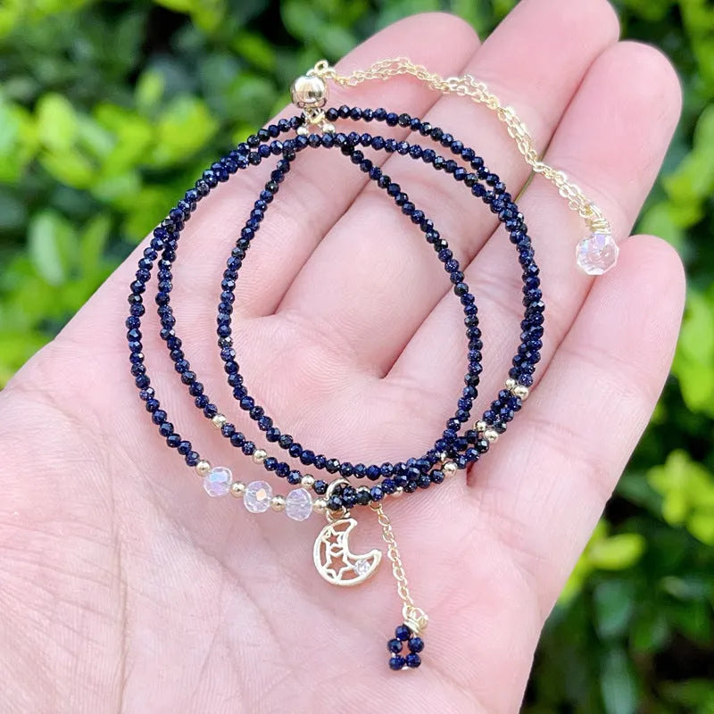 Handmade multi-layer women's bracelet in blue sand colour with three rings and stone-cut beads.