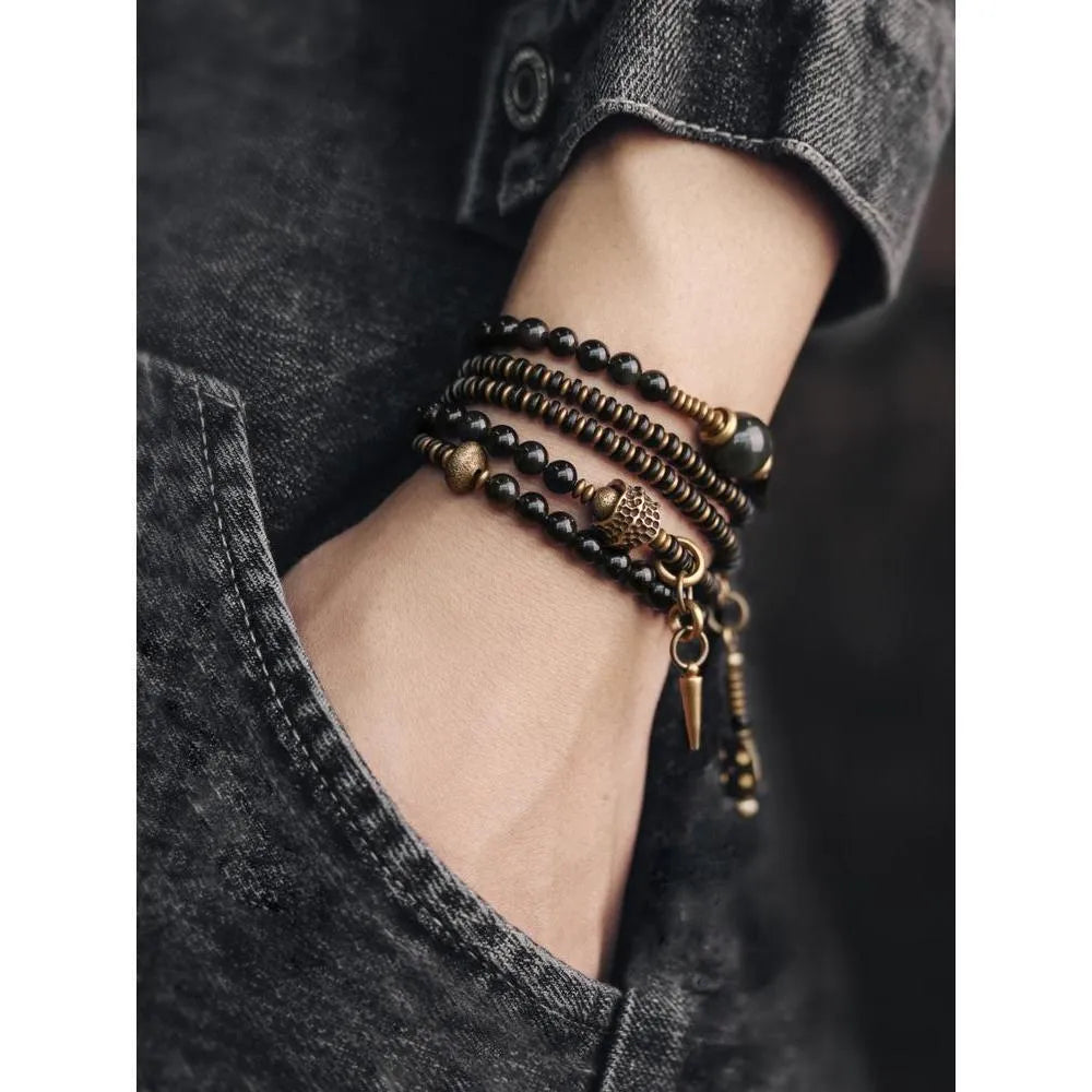 Black geometric beaded bracelet with colourful layered retro design.