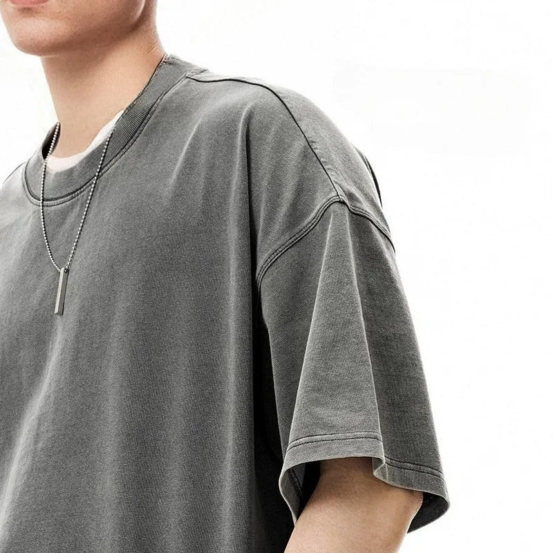 Men's vintage cotton t-shirt with washed-out treatment in khaki light colour showing loose fit and drop-shoulder sleeves