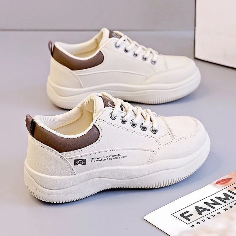 Women's white Korean-style low-top pumps with cross straps and round toe on a rubber sole.