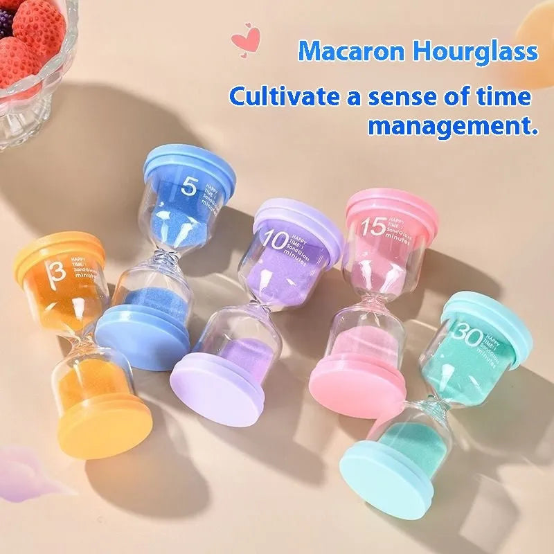Handmade glass sand clock timer on a desk, showing purple sand, modern design.